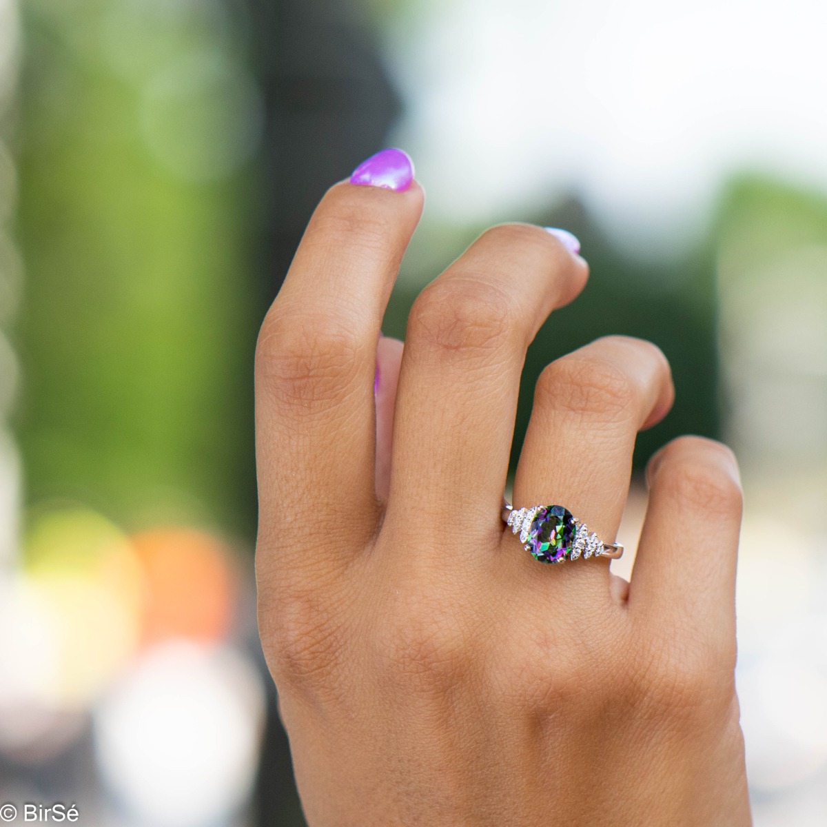 An elegant women's ring with precision craftsmanship entirely of shiny rhodium silver and a spectacular pineapple shape of natural mystic topaz stone with zircons.