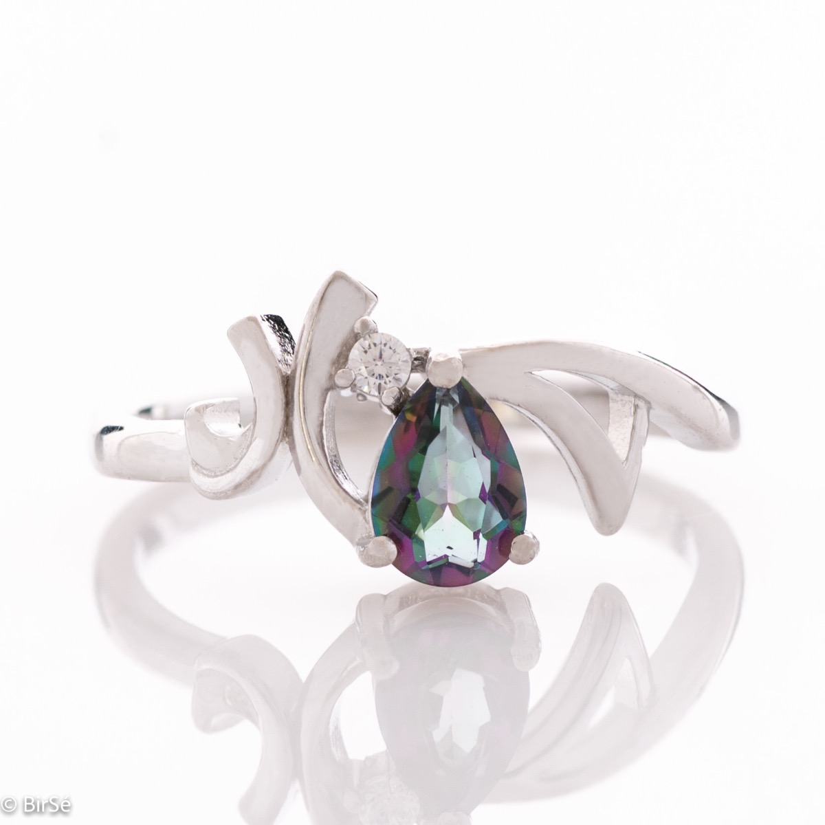 A spectacular women's ring with exquisite workmanship entirely in rhodium-plated silver with gentle curves surrounding a droplet of natural mystic topaz.