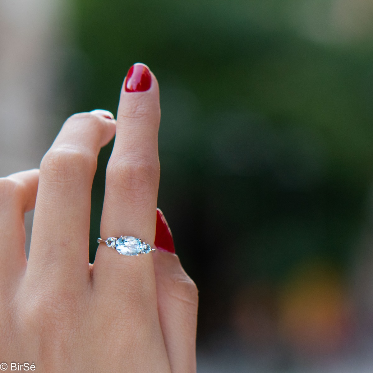 A stylish new offering for your jewelry collection. A ladies ring made entirely of fine rhodium silver that gently envelops a dazzling blue topaz.