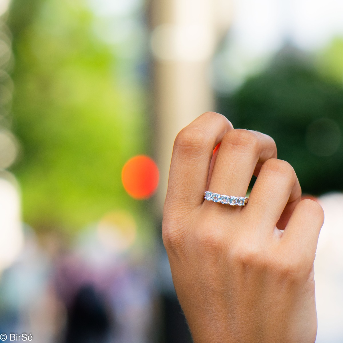 A dazzling ring of beautiful rhodium-plated sterling silver and a row of lovely sky blue topazes.