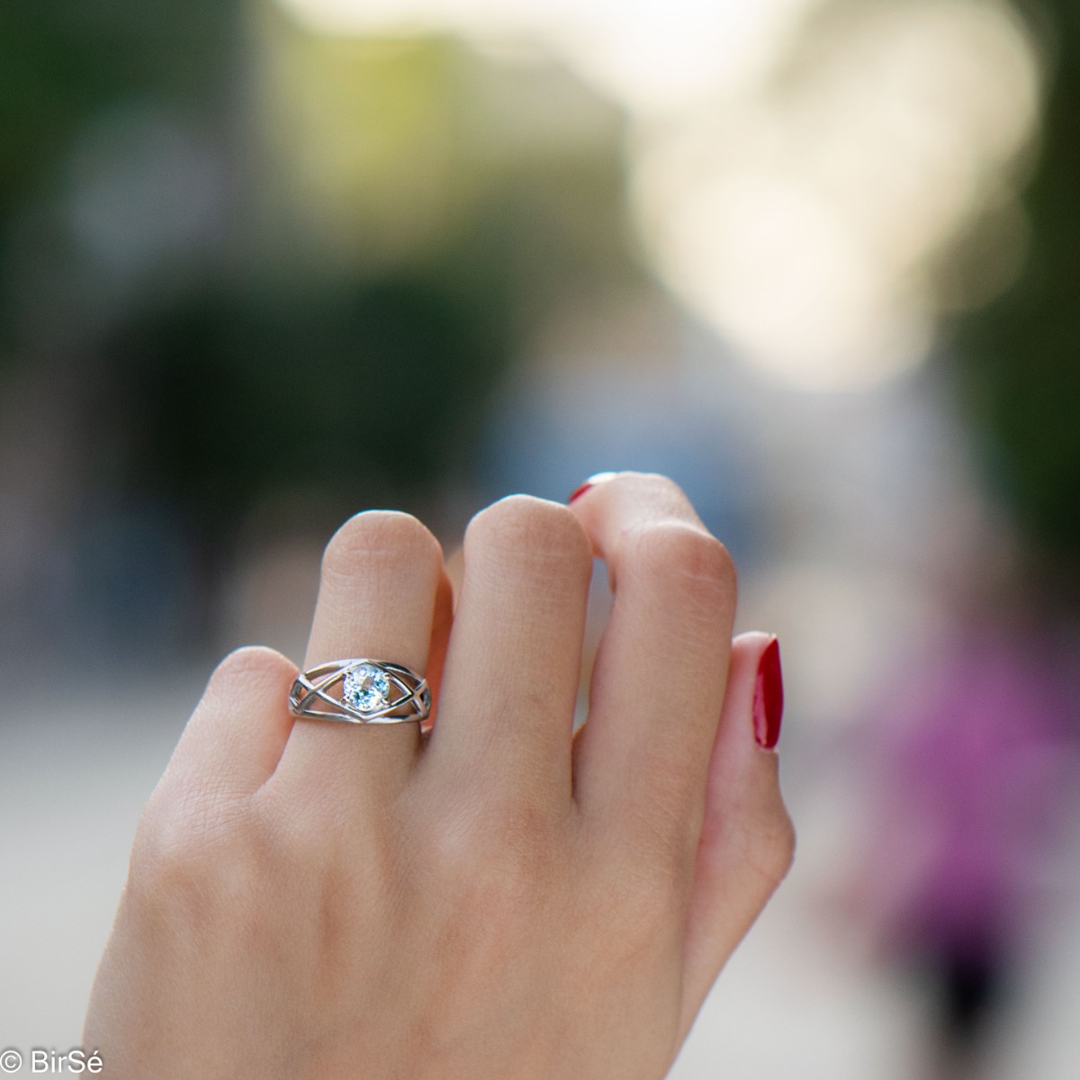 Delightful rhodium silver and natural blue topaz ring. The seductive charm of the stone can captivate any stylish and sophisticated lady