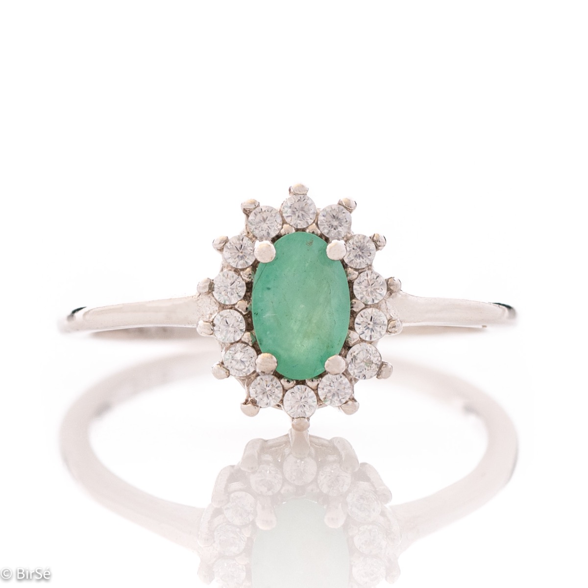 An elegant women's ring with delicate rhodium-plated sterling silver craftsmanship combined with a radiant emerald natural stone surrounded by sparkling zircons. Can be combined with earrings, necklace and bracelet of the same model.