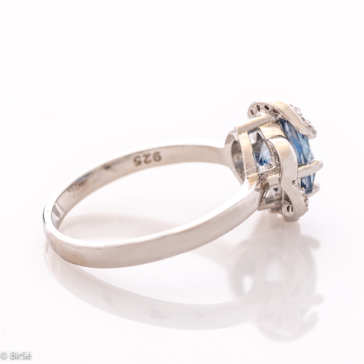 Gentle glow of a natural blue mystic topaz stone complemented by fine sparkling zircons - our new ladies' ring with exquisite details and curves. Part of a charming earring and pendant set.