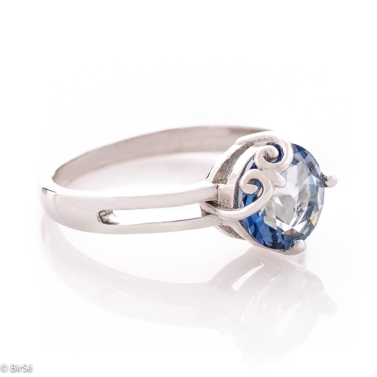 An elegant women's ring with a sparkling natural blue mystic topaz stone, intertwined with beautiful curves made entirely of elegant rhodium-plated silver.