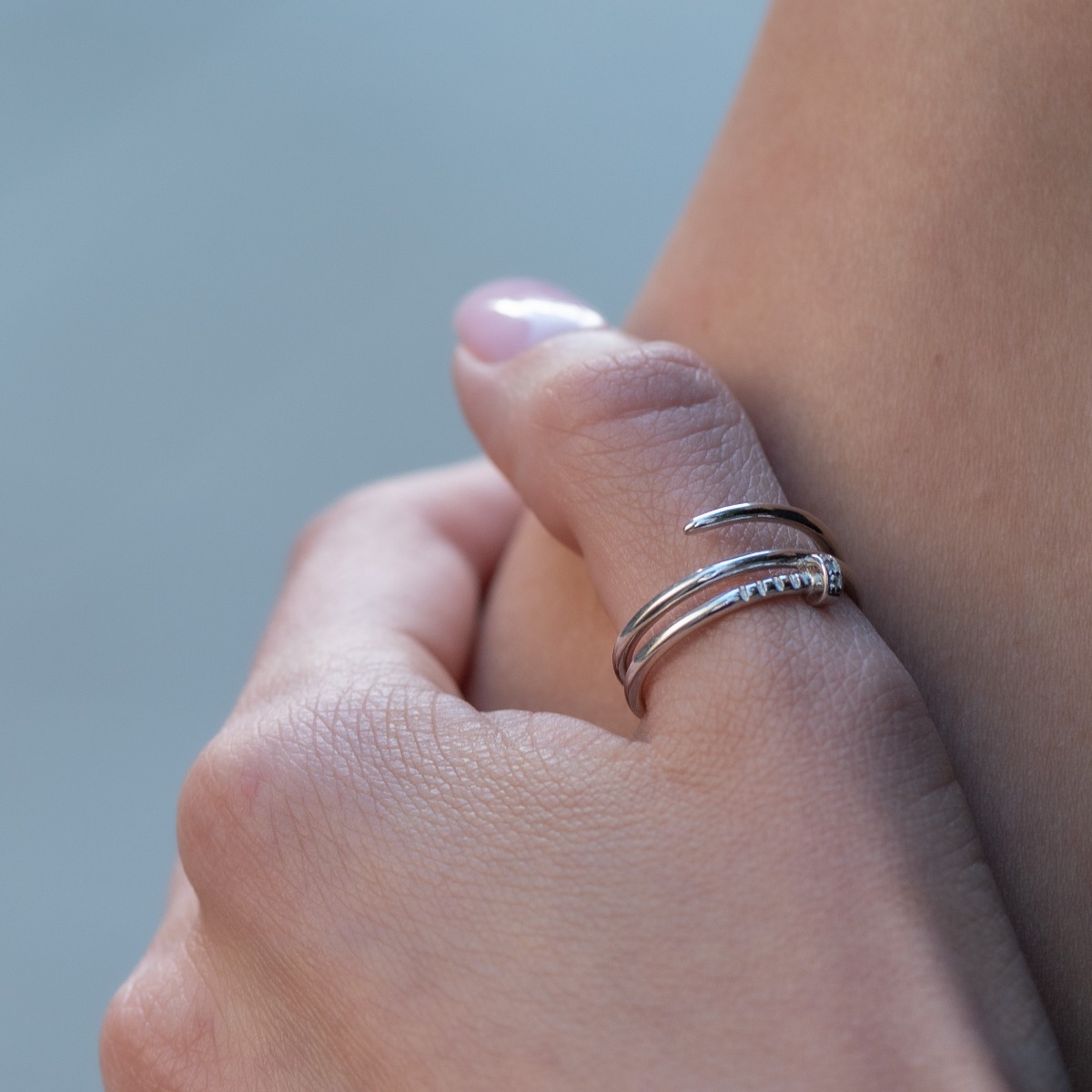 Tempting with its modern style and look, this silver stud ring is a sought after and preferred piece of jewelry by many young girls or stylish ladies. A few sparkling zircons add extra charm and sparkle.