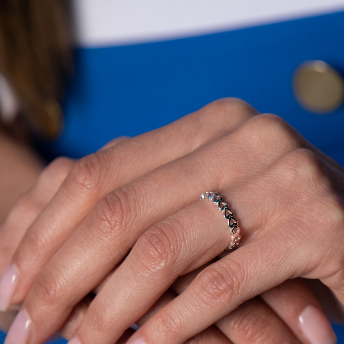 A charming silver ring in classic shiny silver with a row of delicate clean hearts. The ring can be successfully combined with earrings and a necklace with a heart.