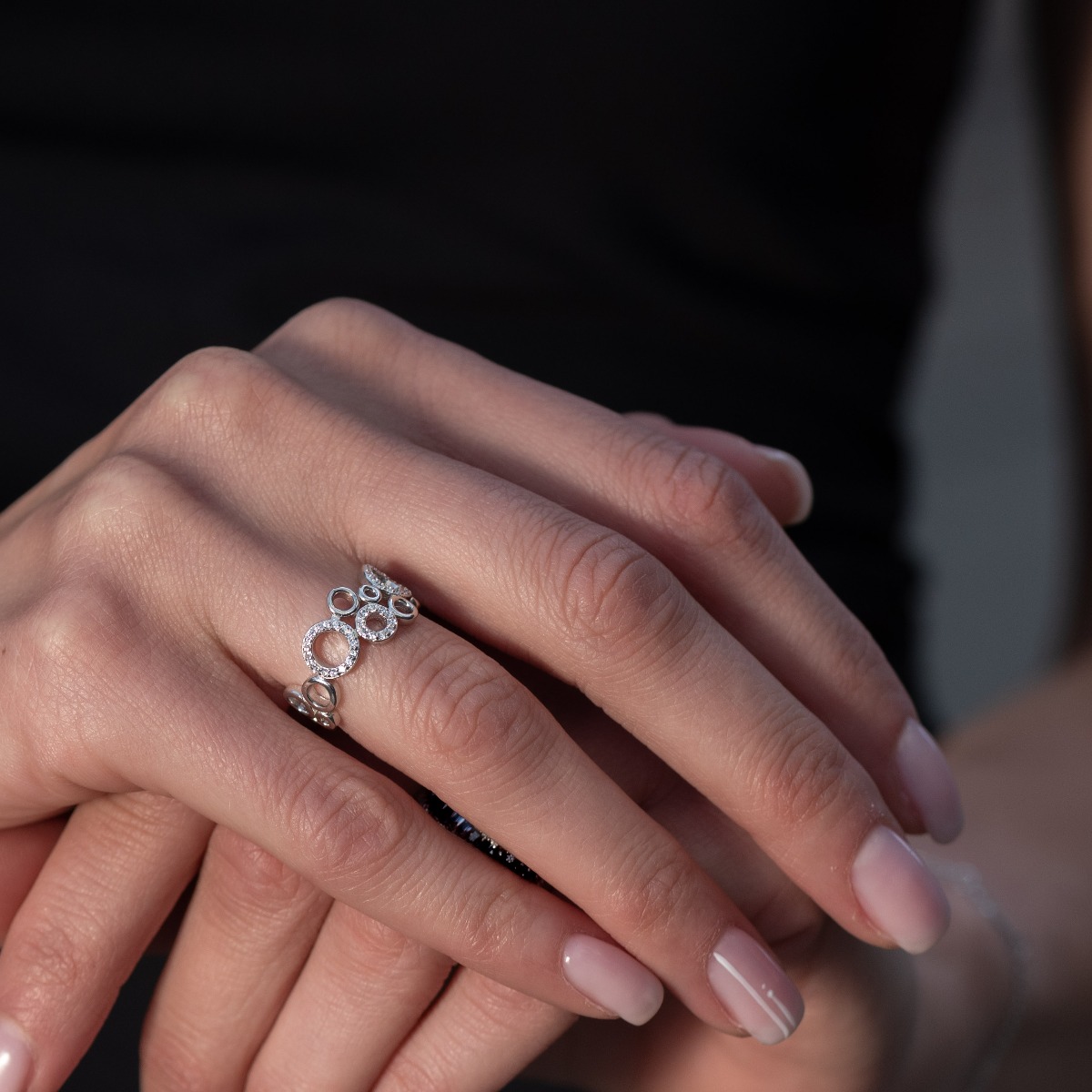 A spectacular women's ring with a non-standard design and exquisite workmanship entirely of soft rhodium-plated silver combined with glittering zircons.