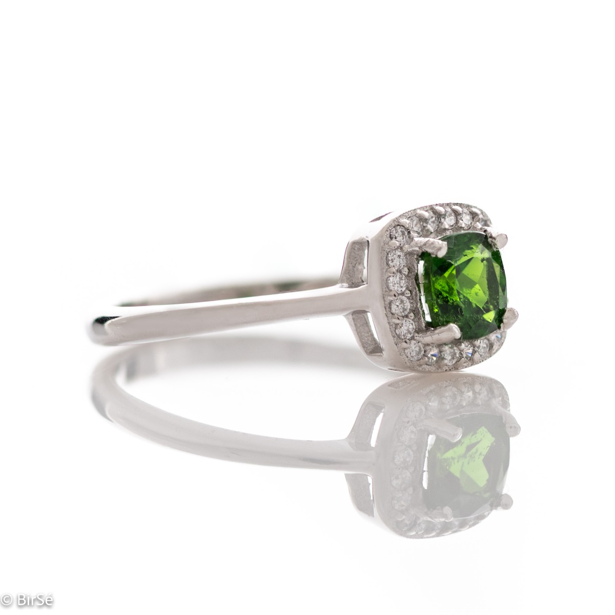 An elegant ring with precise craftsmanship from soft rhodium-plated silver. At the center of the jewel is set a mesmerizing green Chrome Diopside stone in the company of sparkling zircons. Part of a sophisticated set including a pendant and stud earrings.