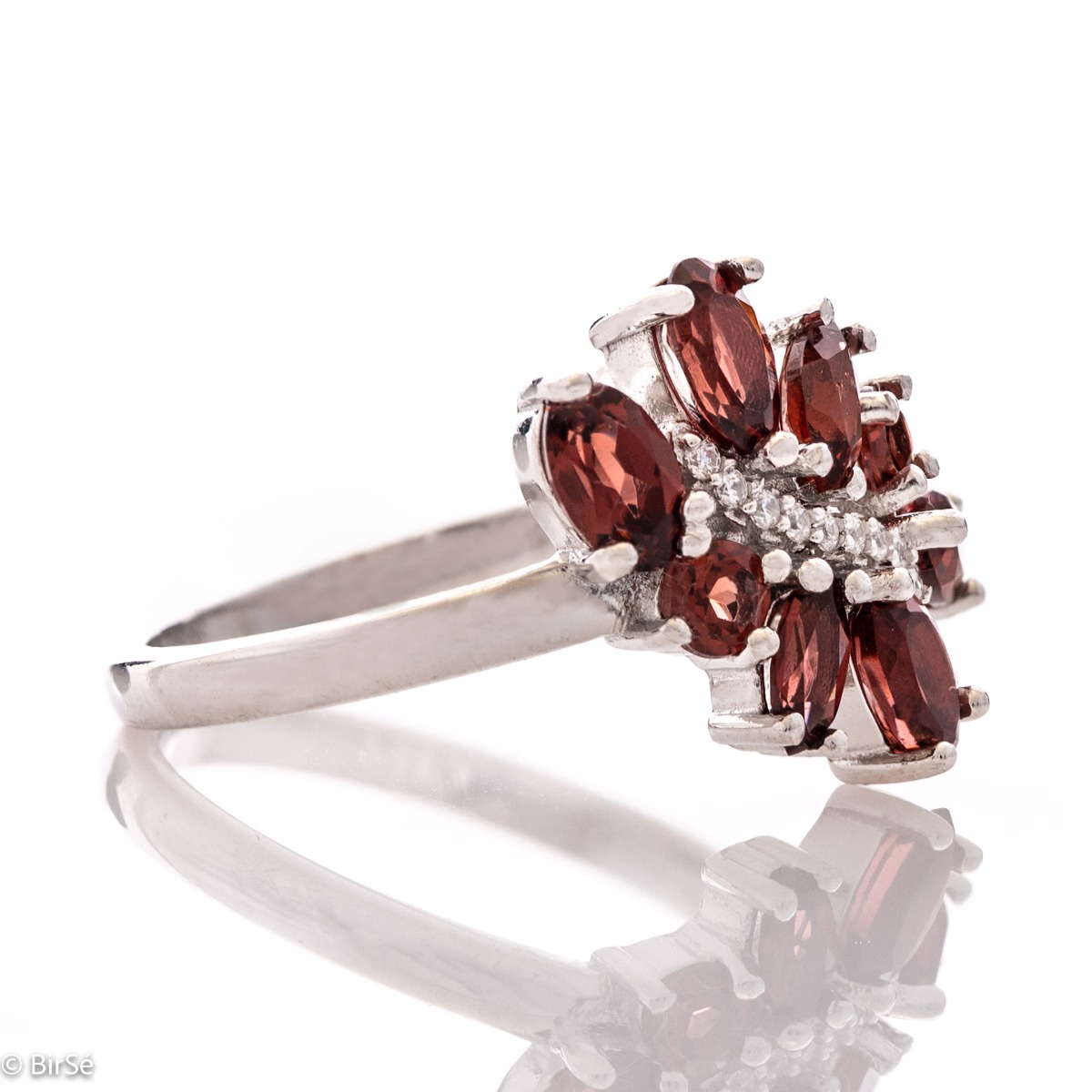 Delicately elegant silver ring with a charming look and innovative design. Stylish craftsmanship from a fine combination of rhodium-plated silver with charming natural garnet stones and delicate zircons.