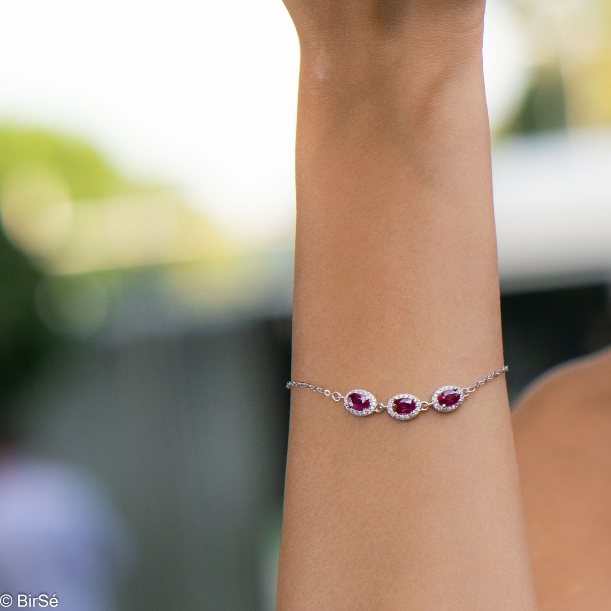 Elegant women's bracelet made of soft silver with natural ruby ​​stones, decorated with exquisite and subtle elements and sparkling zircons. The bracelet has an extension, for greater convenience when adjusting the length.