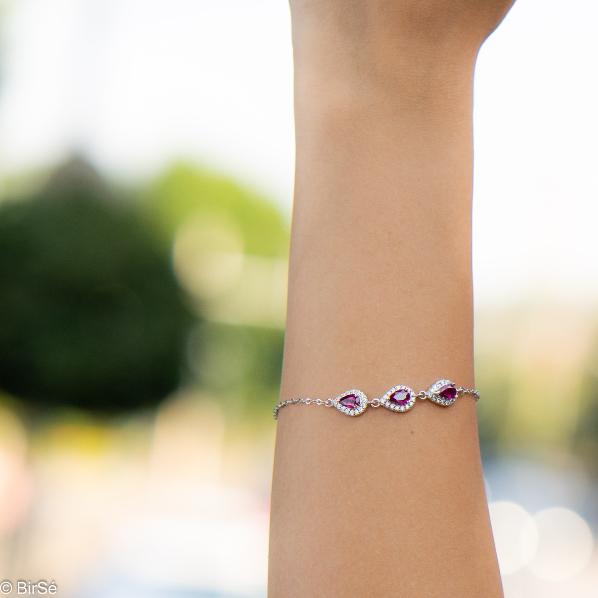 Elegant women's bracelet made of soft silver with natural ruby ​​drops, decorated with exquisite and subtle elements and sparkling zircons. The bracelet has an extension, for greater convenience when adjusting the length.