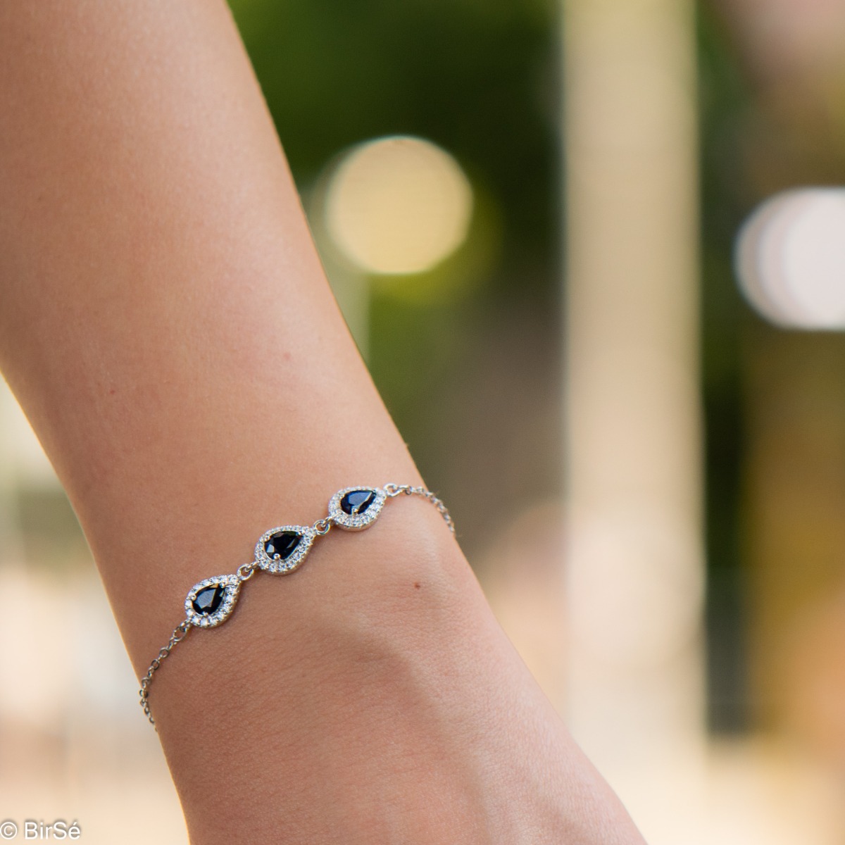 Elegant women's bracelet in soft silver with natural sapphire drops, decorated with exquisite and subtle elements and sparkling zircons. The bracelet has an extension, for greater convenience when adjusting the length.