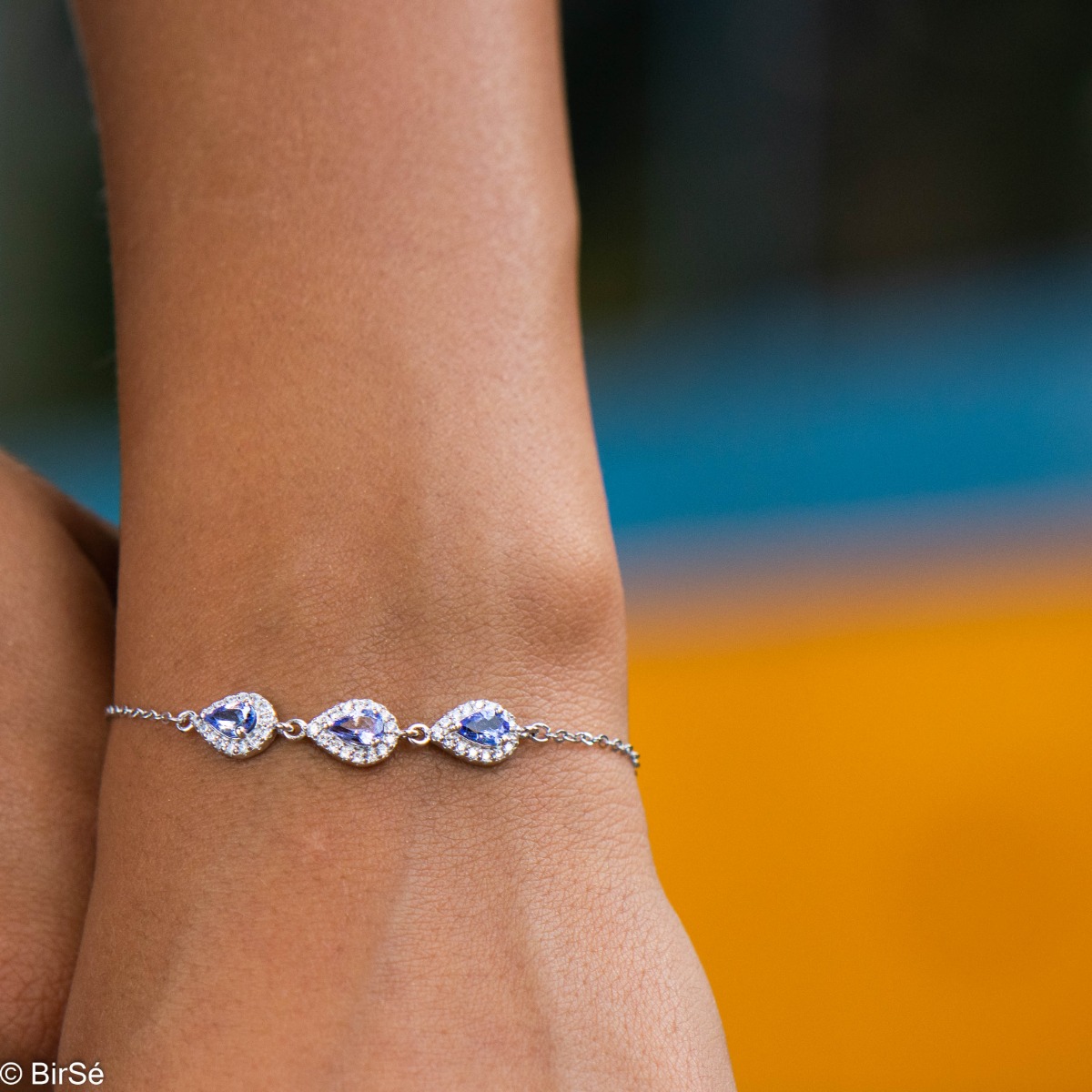 Elegant women's bracelet in soft silver with natural tanzanite drops, decorated with exquisite and subtle elements and sparkling zircons. The bracelet has an extension, for greater convenience when adjusting the length.