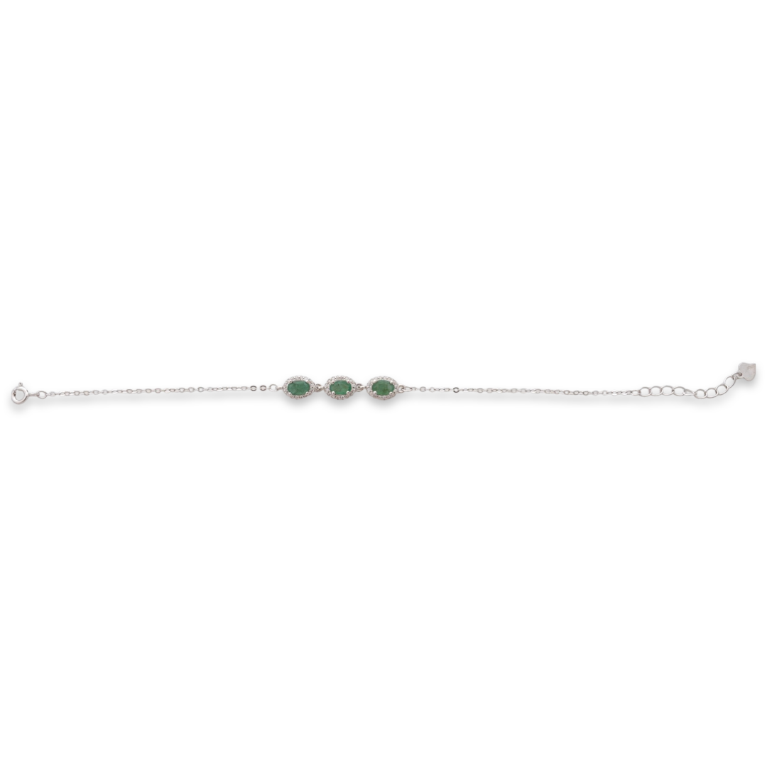 An elegant women's bracelet made of soft silver with natural emerald stones, decorated with exquisite and subtle elements and sparkling zircons. The bracelet has an extension, for greater convenience when adjusting the length.