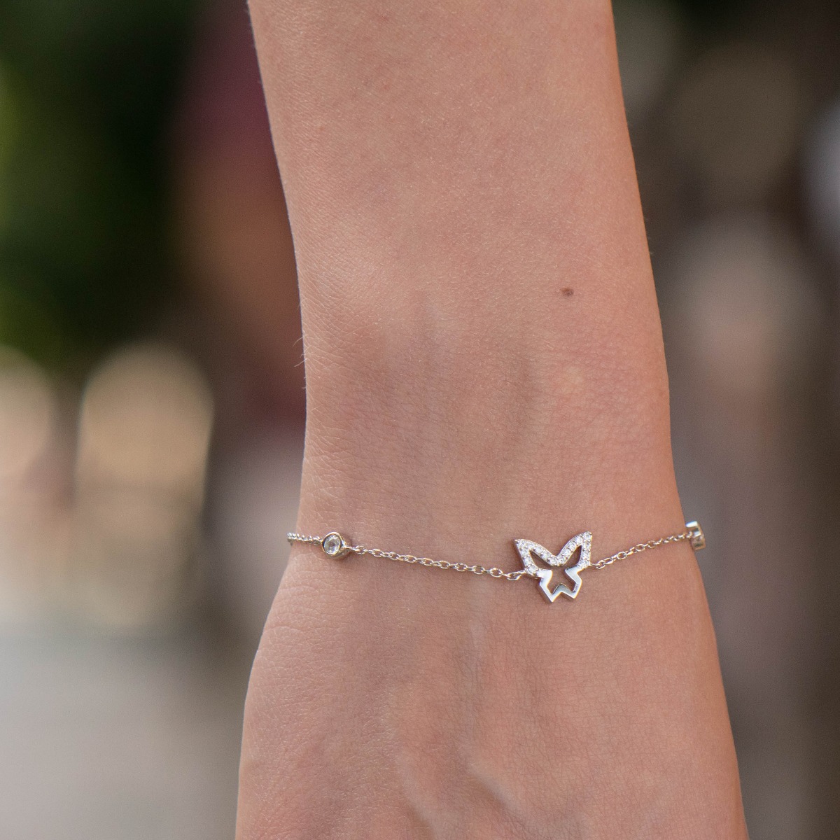 An exotic women's bracelet in soft silver with exquisite craftsmanship, decorated with an elegant butterfly and sparkling zircons. The bracelet has an extension, for more convenience when adjusting the length.