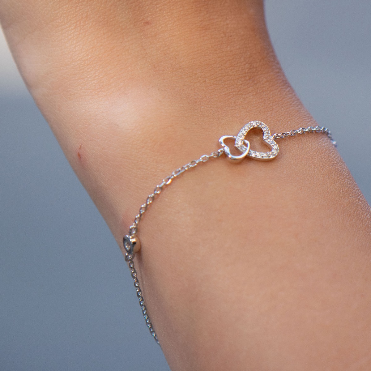 A shiny silver bracelet with a spectacular design and glittering hearts with zircons. An elegant gift for any lady. The bracelet has an extension, for convenience when adjusting the length.