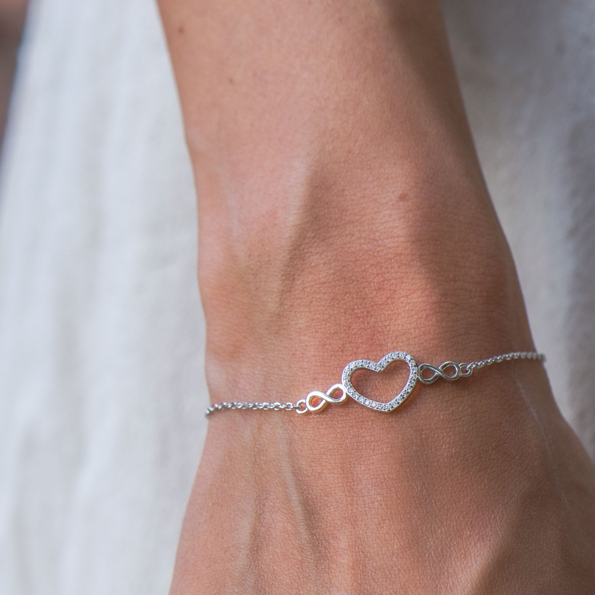 Ethereal women's jewelry made of soft silver with exquisite heartwork with zircons and ethereal infinities. The fine women's bracelet has an extension, for more convenience when adjusting the length.