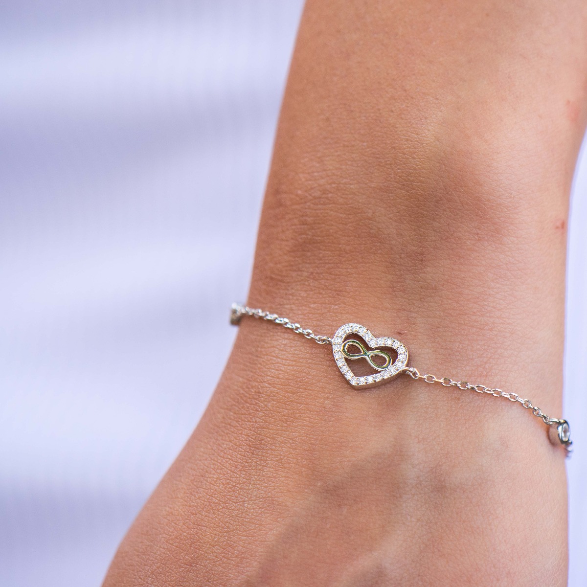 Charming women's bracelet in soft silver with an exquisitely crafted heart encrusted with sparkling zircons. A subtle infinity elegantly complements the heart. The bracelet has an extension, for more convenience when adjusting the length. A new offer from