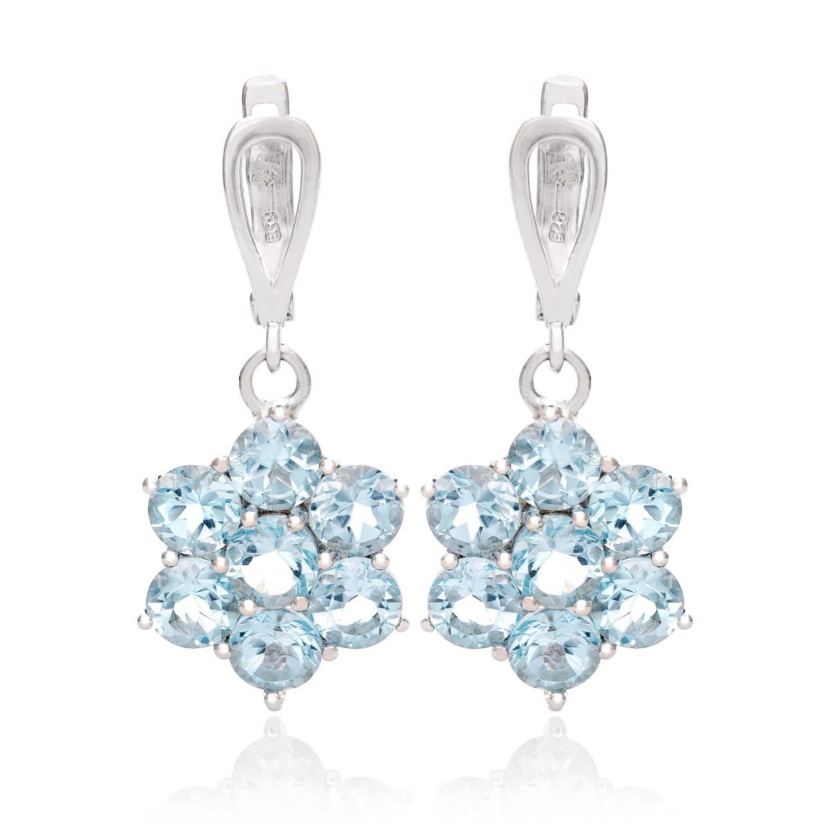 Exquisitely crafted earrings of beautiful rhodium silver and radiant sky blue topaz arranged in a flower shape. Our new English clasp earrings are part of a charming ring and pendant set.