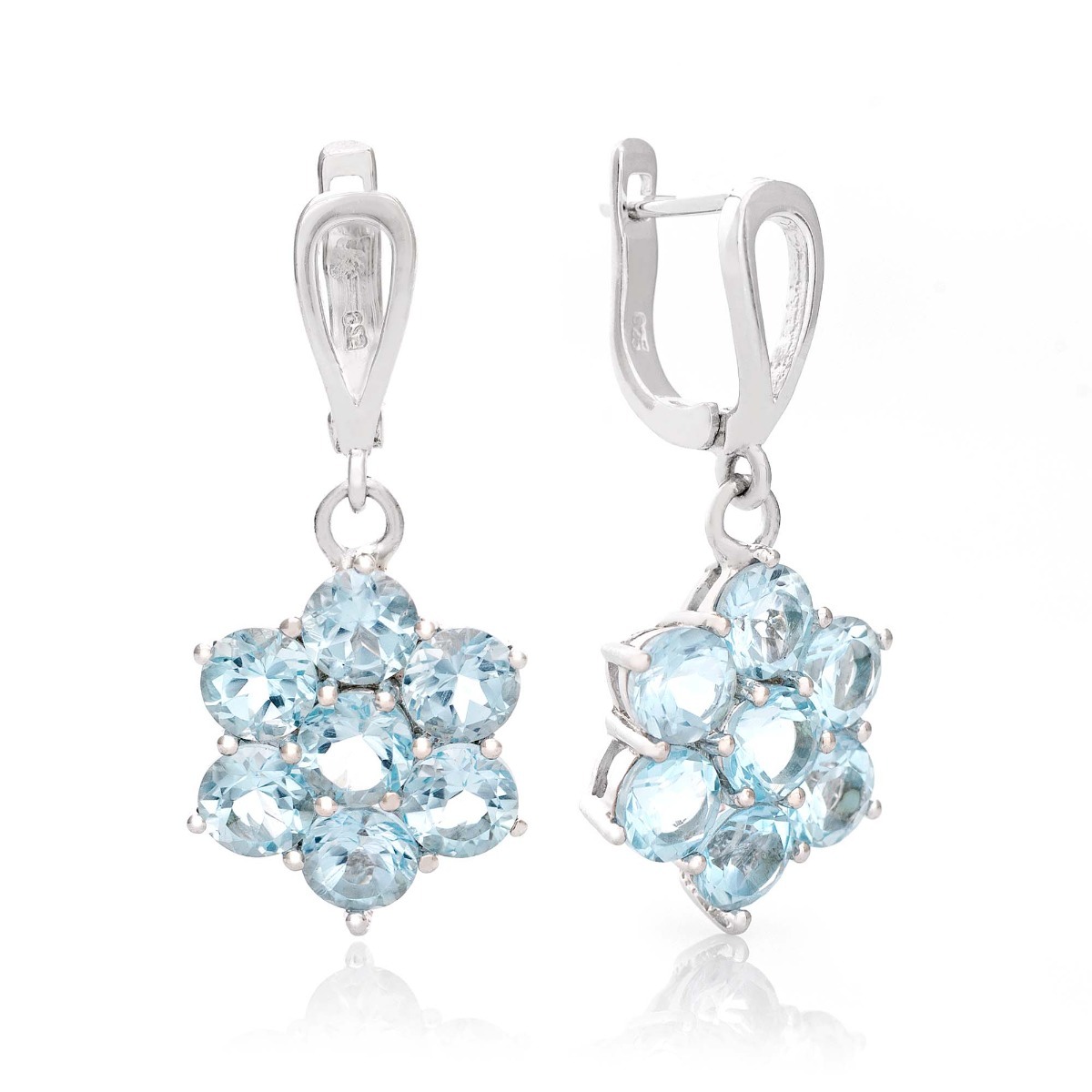 Exquisitely crafted earrings of beautiful rhodium silver and radiant sky blue topaz arranged in a flower shape. Our new English clasp earrings are part of a charming ring and pendant set.