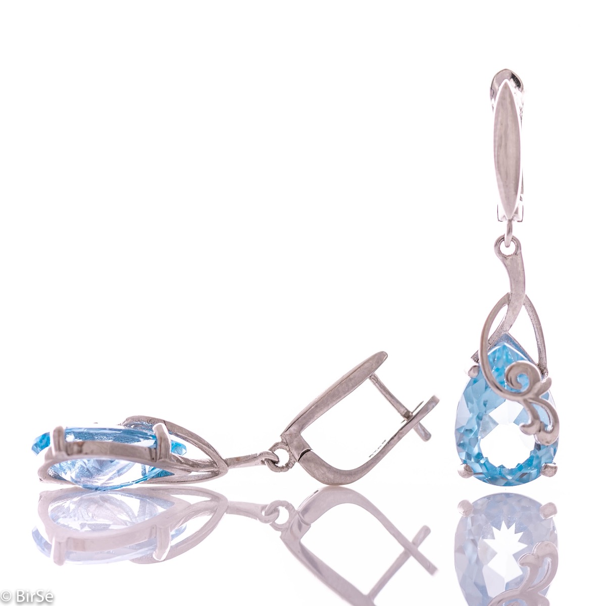 Exclusive pendant earrings with English clasp and exquisite workmanship combining a radiant natural blue topaz in a delicate teardrop shape with shiny rhodium silver. Can be combined with a pendant and a ring of the same model.