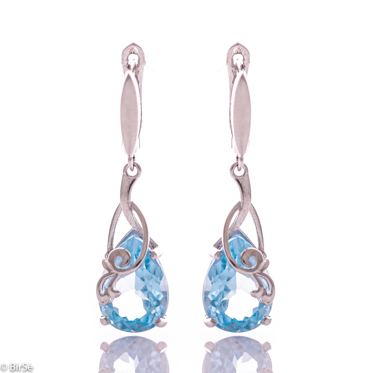 Exclusive pendant earrings with English clasp and exquisite workmanship combining a radiant natural blue topaz in a delicate teardrop shape with shiny rhodium silver. Can be combined with a pendant and a ring of the same model.