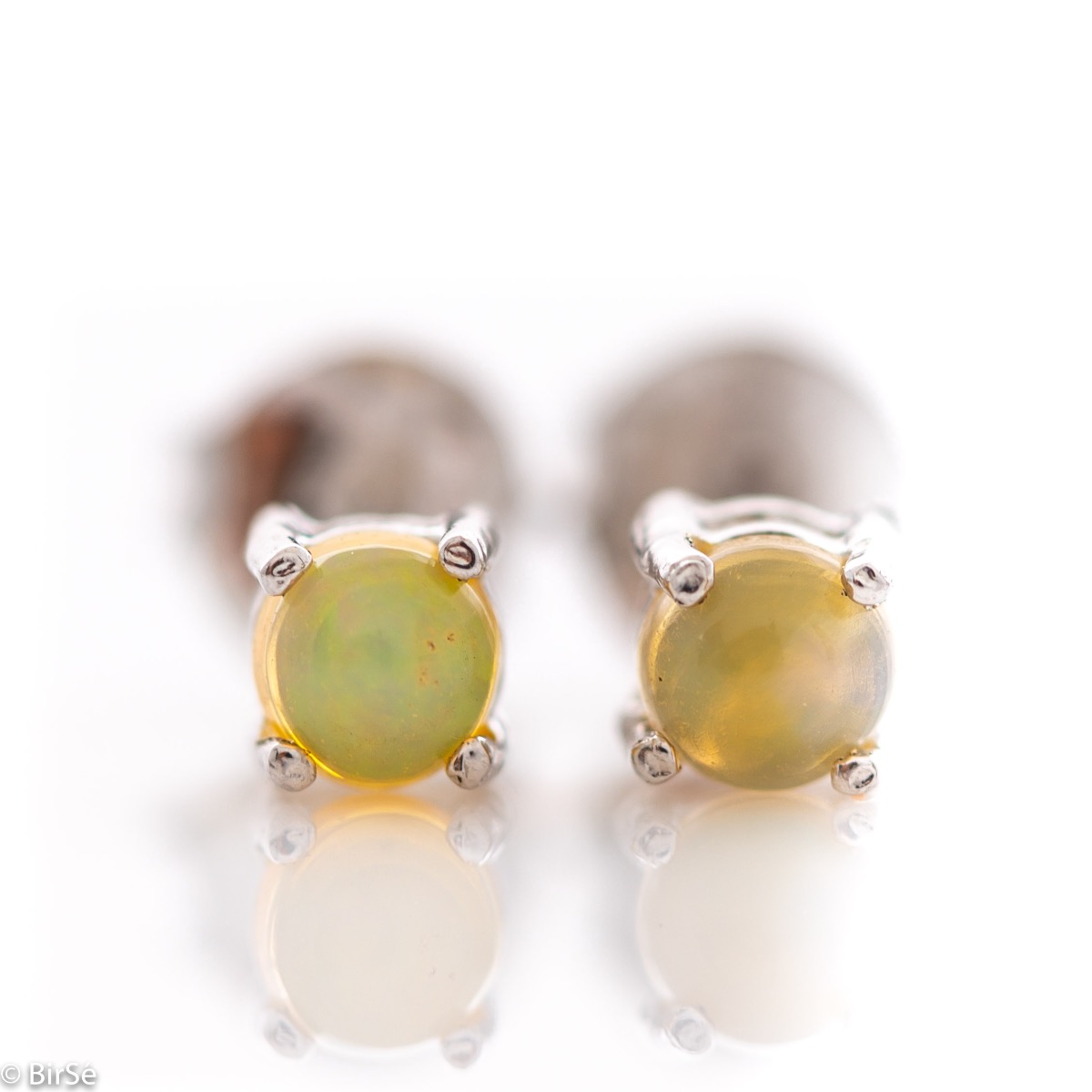 Delicate stud earrings with precision craftsmanship in beautiful rhodium silver, complemented by a fine and multi-colored natural opal stone. Also suitable for children.