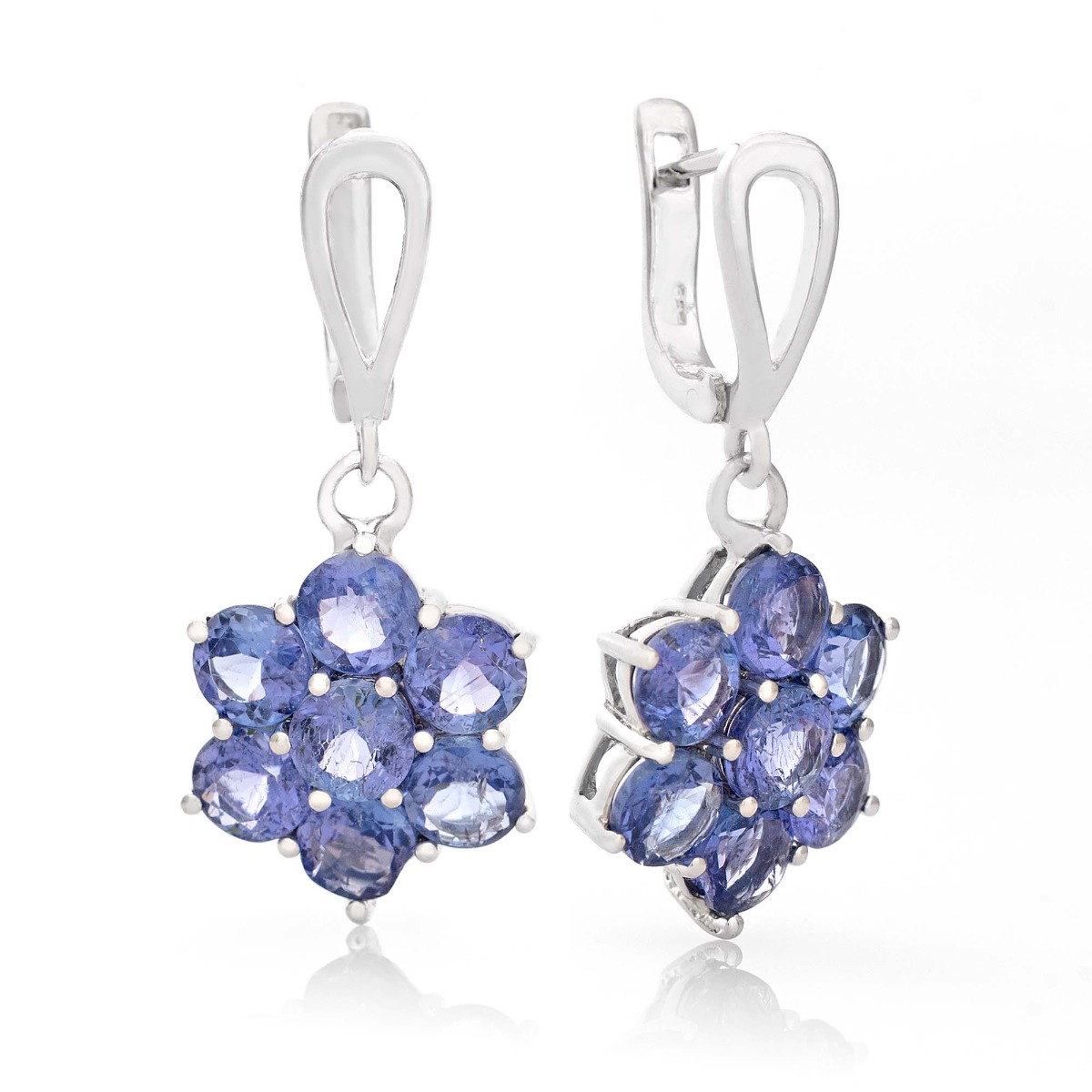 Captivating earrings crafted from beautiful rhodium silver and radiant natural tanzanite arranged in a flower shape. Our new English clasp earrings are part of a charming ring and pendant set.