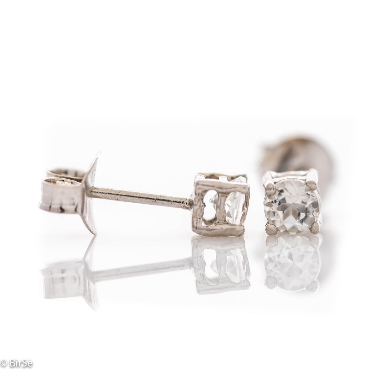 Delicate stud earrings with precision craftsmanship in beautiful rhodium silver, complemented by a fine and radiant natural white topaz. Also suitable for children.