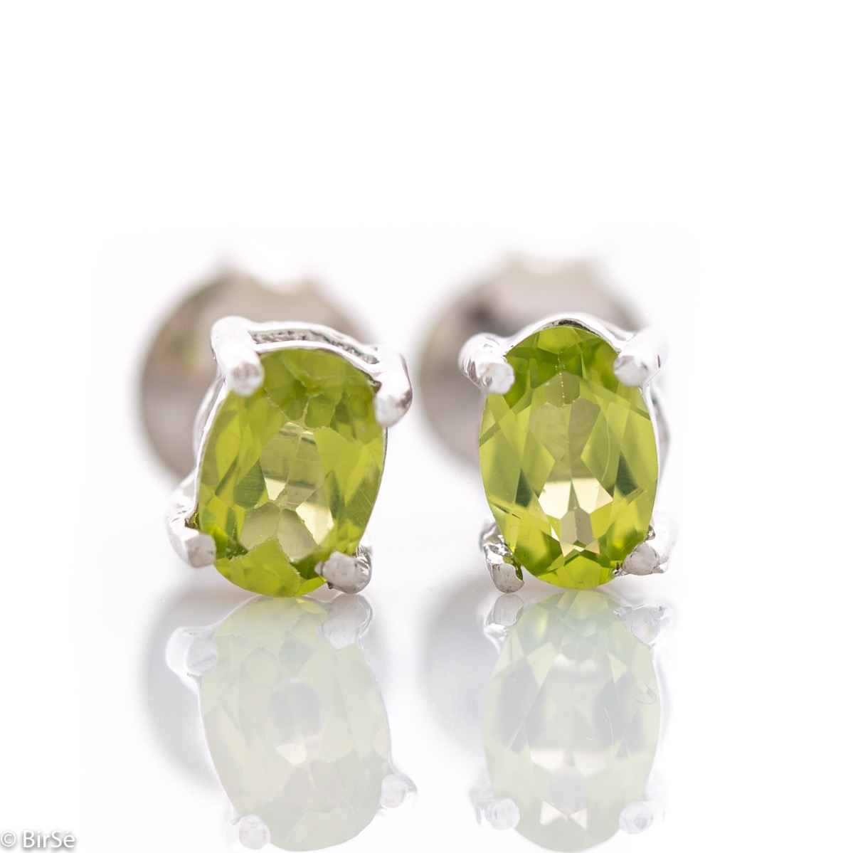 The gentle glow of a beautiful natural peridot stone combined with fine craftsmanship in all rhodium silver, in our new women's stud earrings.