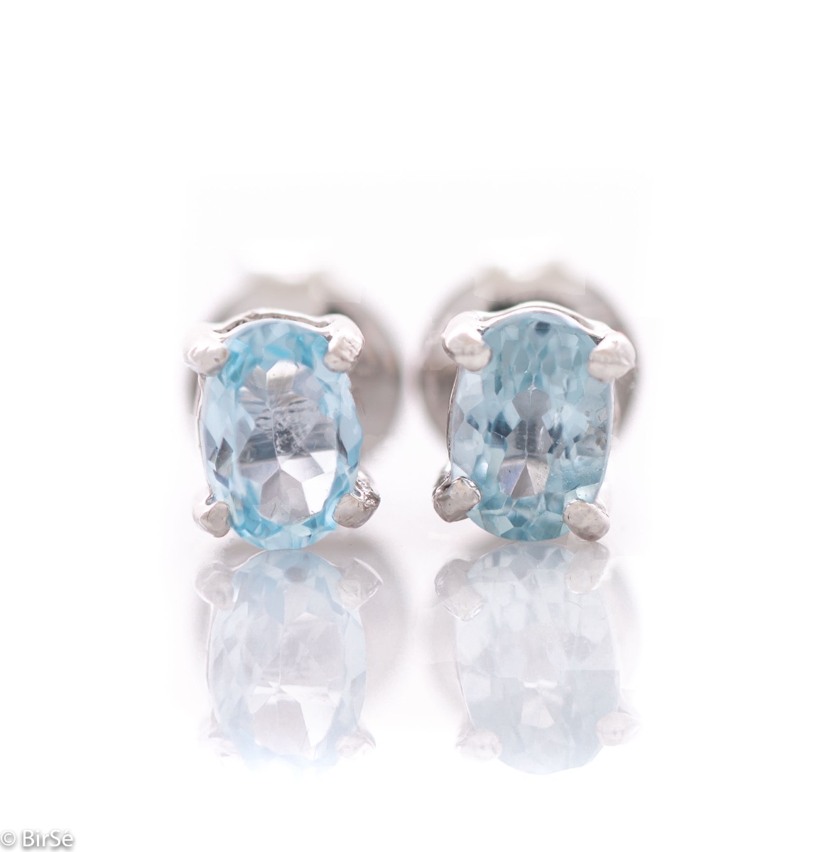 The soft blue glow of a beautiful blue topaz natural stone, combined with fine craftsmanship in all rhodium silver, in our new women's stud earrings.