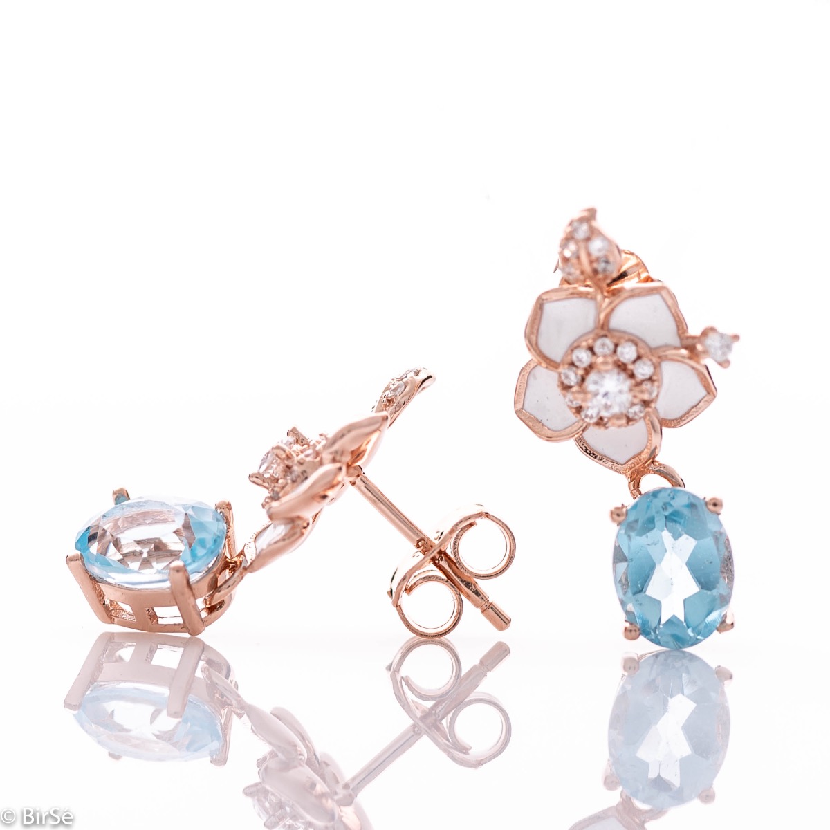 Exquisite women's earrings delicately crafted from rhodium-plated rose silver, combined with radiant natural blue topaz stones and beautiful floral elements with sparkling zircons.