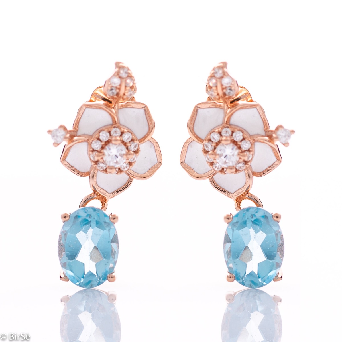 Exquisite women's earrings delicately crafted from rhodium-plated rose silver, combined with radiant natural blue topaz stones and beautiful floral elements with sparkling zircons.