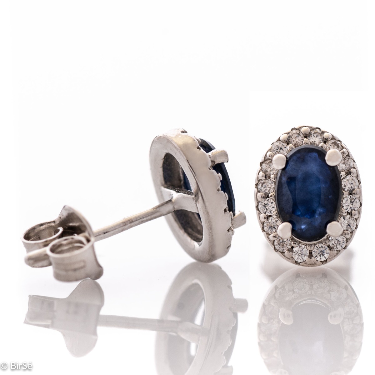 Royal vision - stunning silver earrings with a spectacular look and pin fastening. An elegant composition made of a fine combination of rhodium-plated silver with an exquisite sapphire and dazzling zircons.