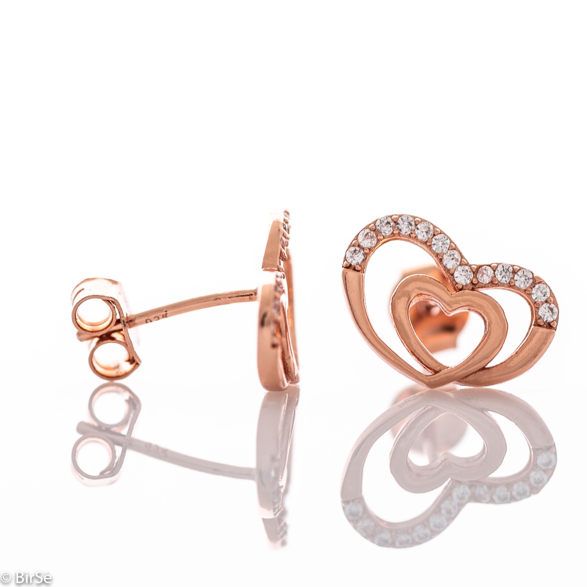 Delicate women's stud earrings with an exquisite shape and precise craftsmanship, combining two intertwined beautiful hearts with rhodium-plated rose silver and sparkling zircons. They can be combined with a pendant of the same model.