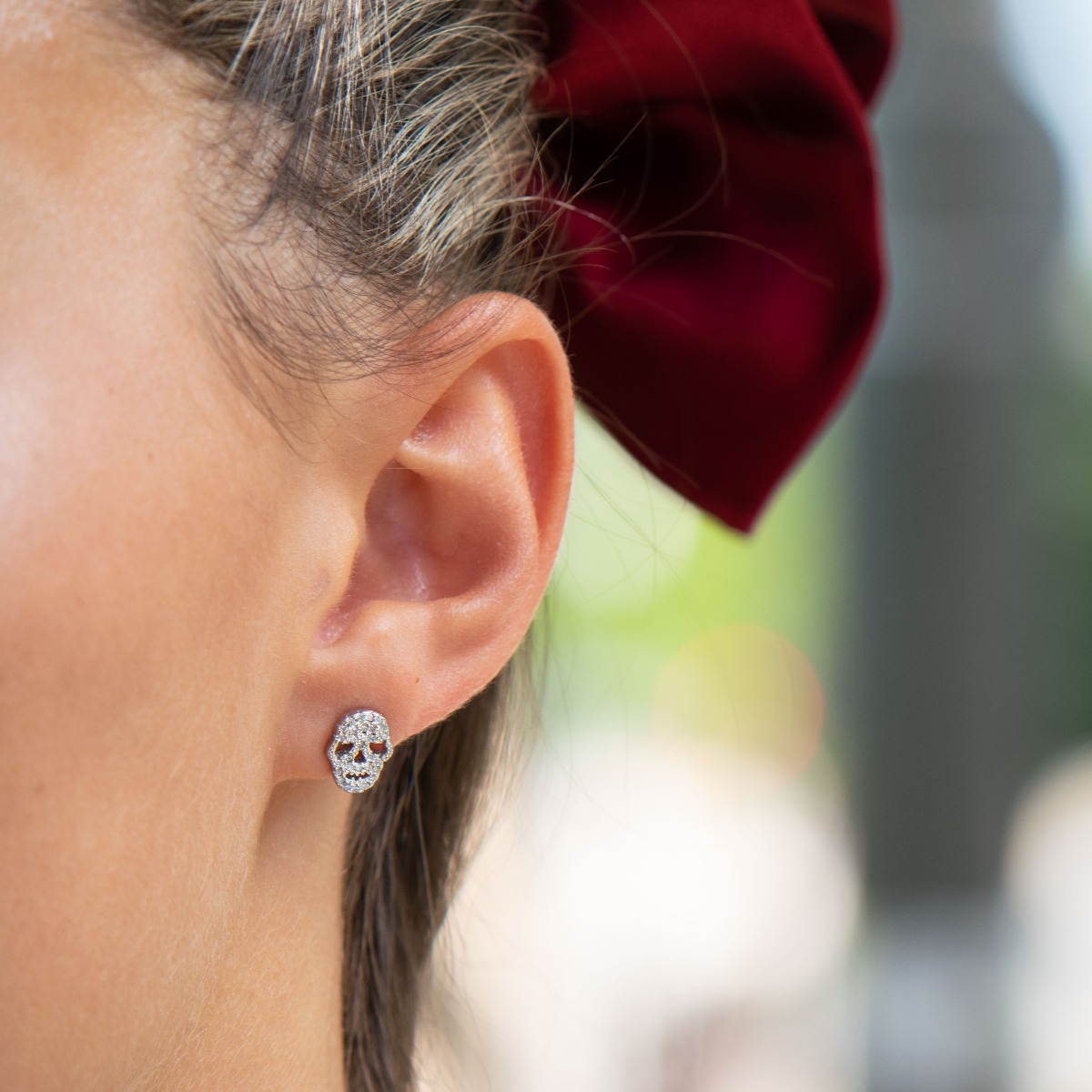 Eccentric women's earrings in fine rhodium silver, with an interesting skull design, covered with zircons. Earrings are a suitable gift for women who admire the unconventional style in jewelry.