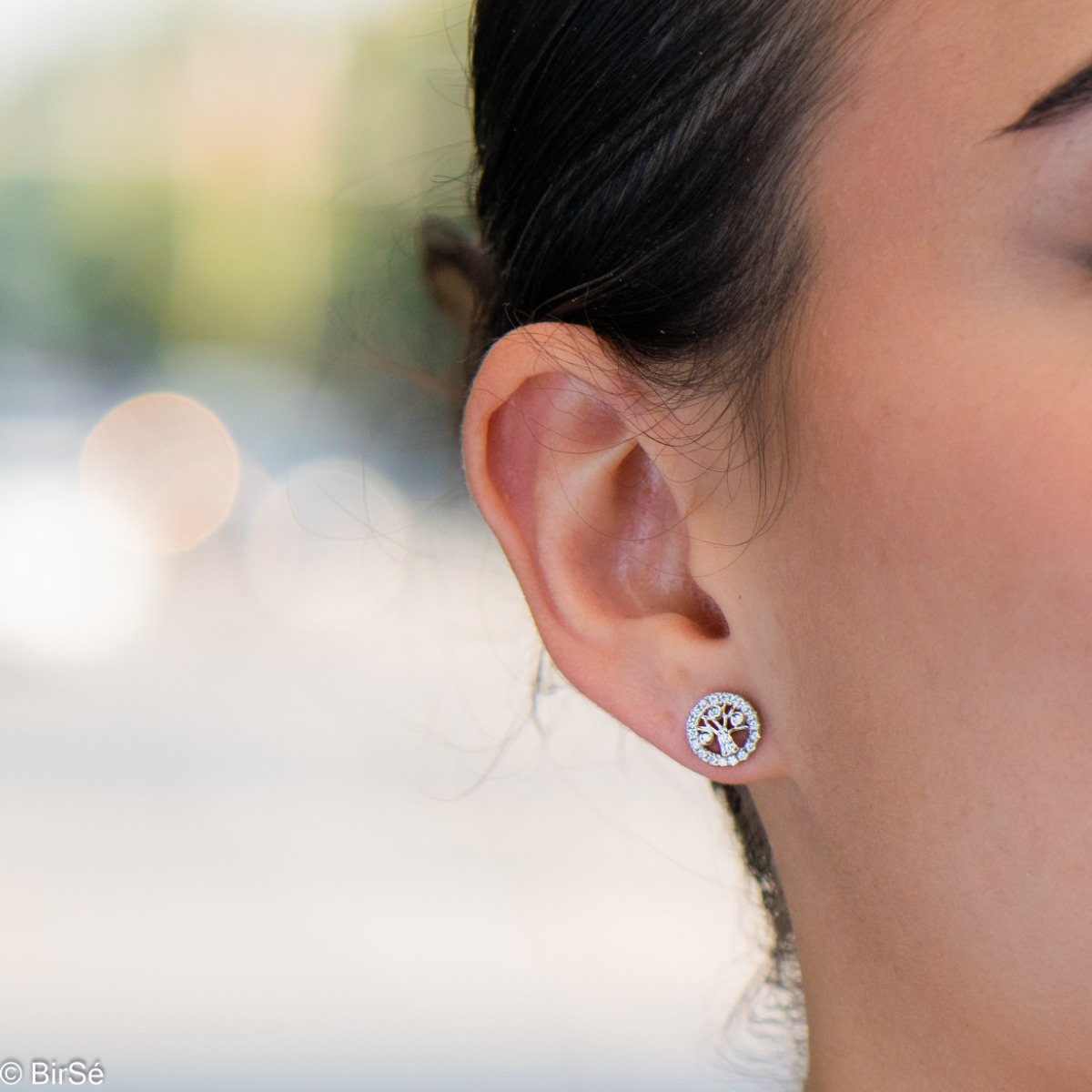 Captivating Women's Tree of Life Stud Earrings. They are made entirely of rhodium-plated silver and are studded with sparkling zircons. These earrings are a wonderful gift for your sweetheart. They can be combined with a pendant of the same model.