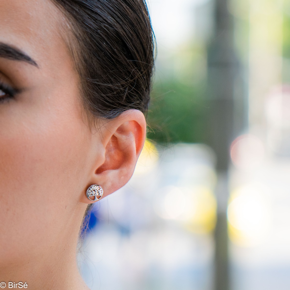 Captivating Women's Tree of Life Stud Earrings. They are made entirely of rhodium-plated silver and sparkling zircons. These earrings are a wonderful gift for your sweetheart. They can be combined with a pendant of the same model.