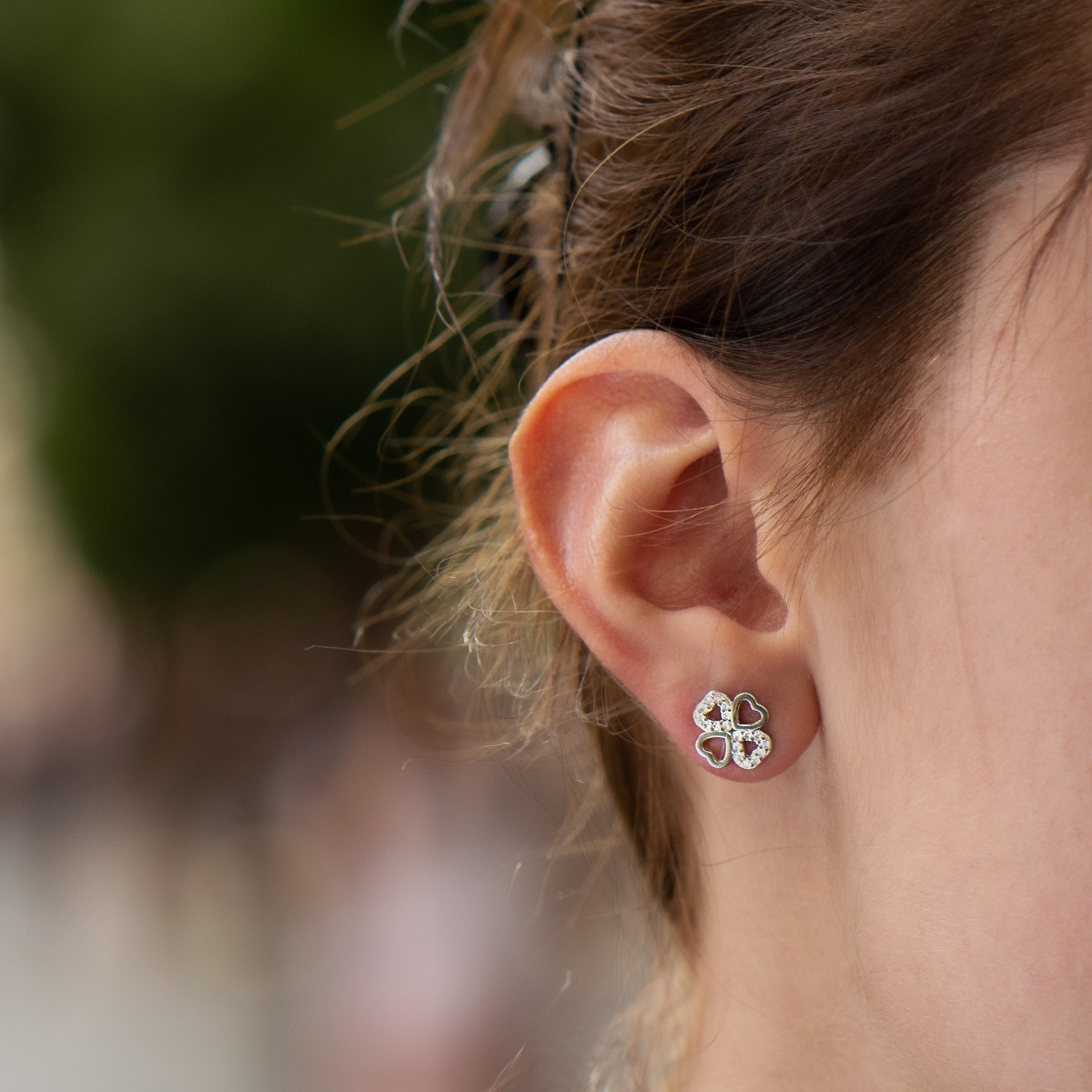 Brilliant craftsmanship of delicate clover earrings with charming design. Made entirely of rhodium-plated silver, hearts connect to form the lucky flower, beautifully decorated with the sparkle of zircons.