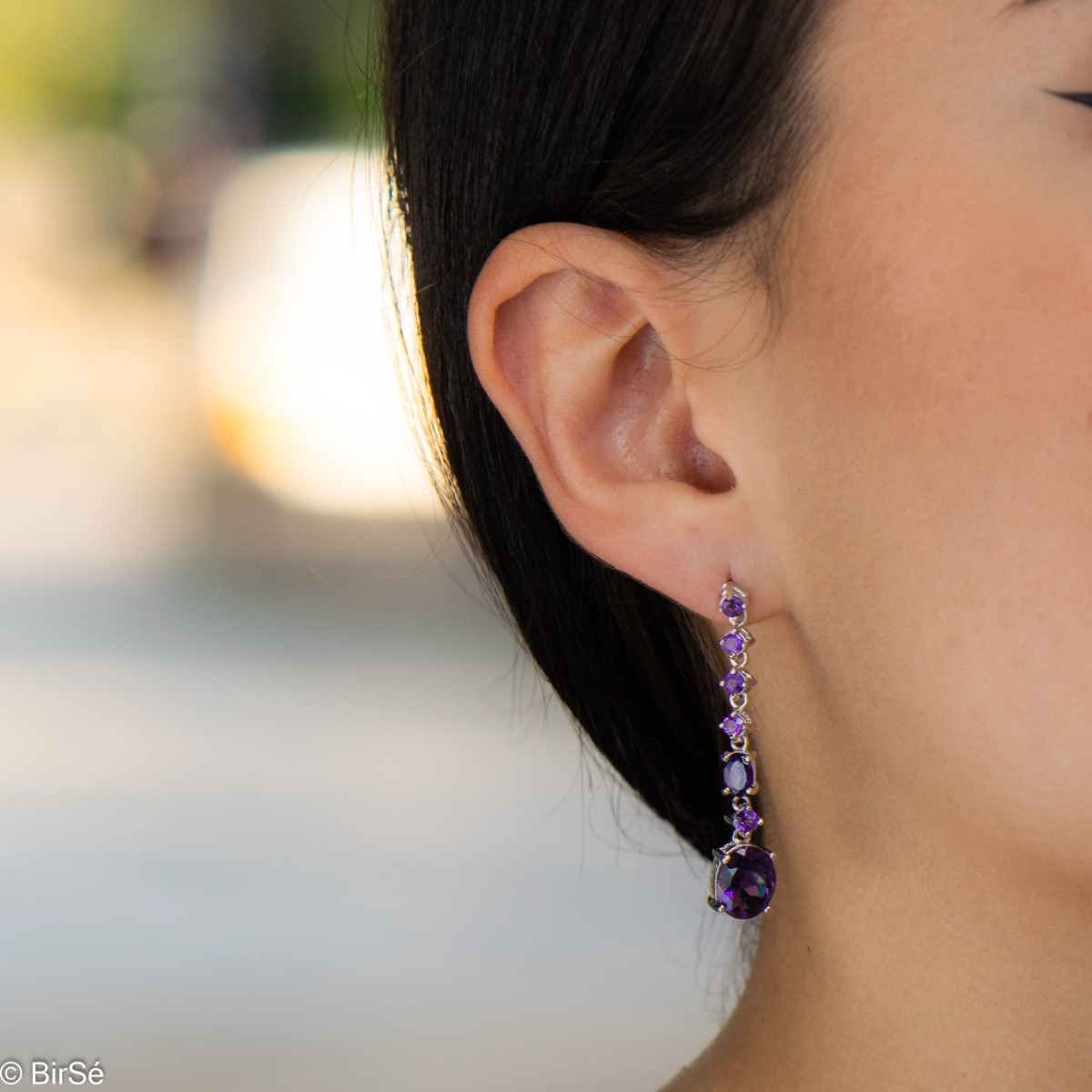 Radiant and spectacular dangling stud earrings with multi-faceted and variously shaped natural amethyst stones and delicately crafted from fine rhodium silver.