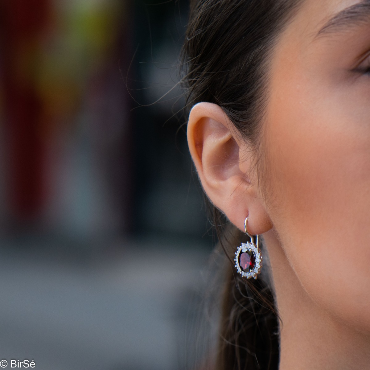 Exclusive women's earrings with exquisite workmanship combining delicate rhodium silver with radiant natural garnet surrounded by sparkling zircons.