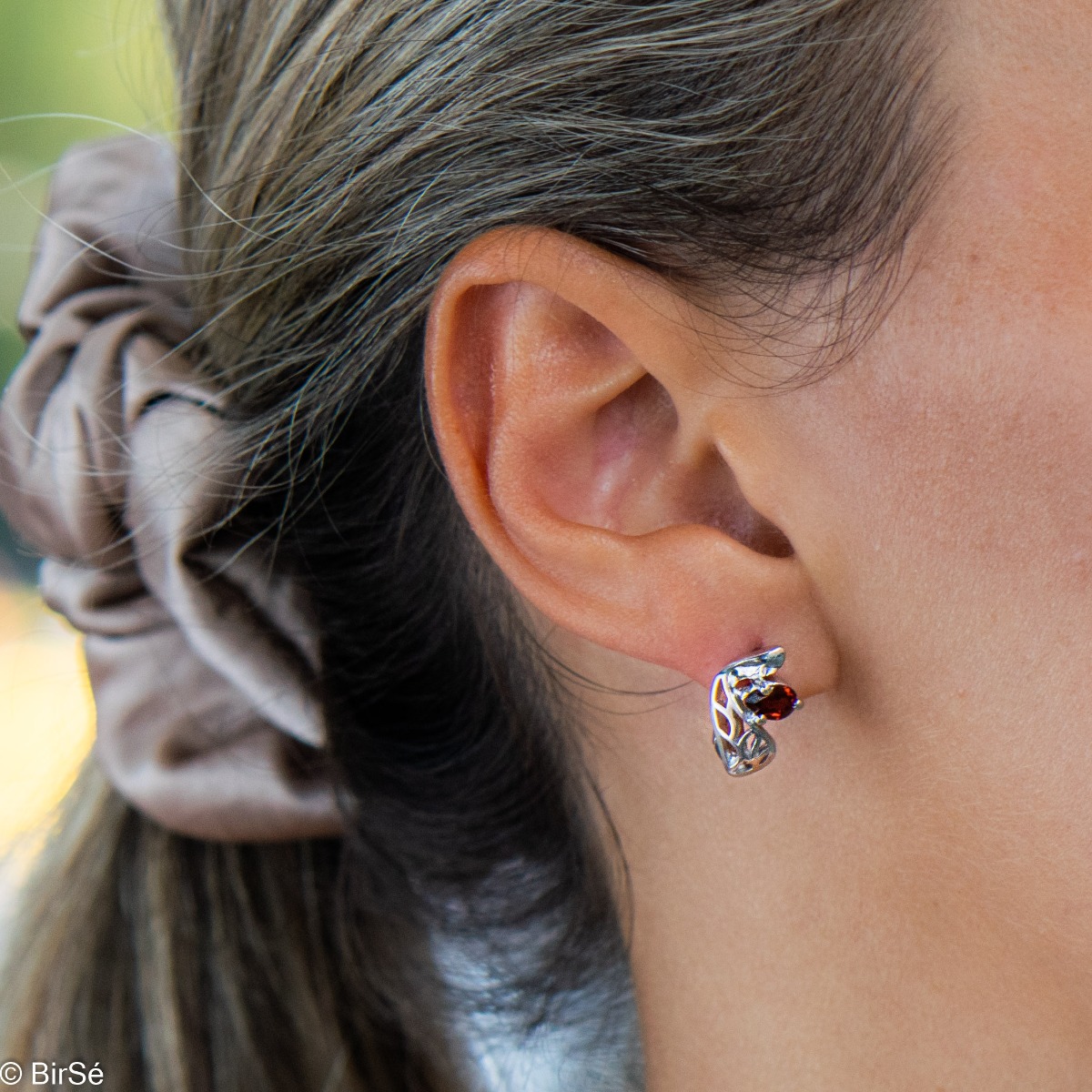 Gentle and spectacular ladies' earrings with English fastening and exquisite workmanship entirely of rhodium-plated silver combined with teardrop-shaped natural garnet. They can be combined with a pendant and a ring from the same set.