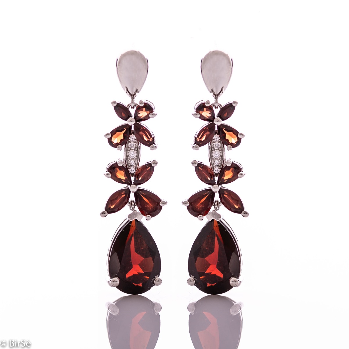 Exquisite silver earrings with precise craftsmanship combining rhodium-plated silver with delicate flowers of natural garnet stone.