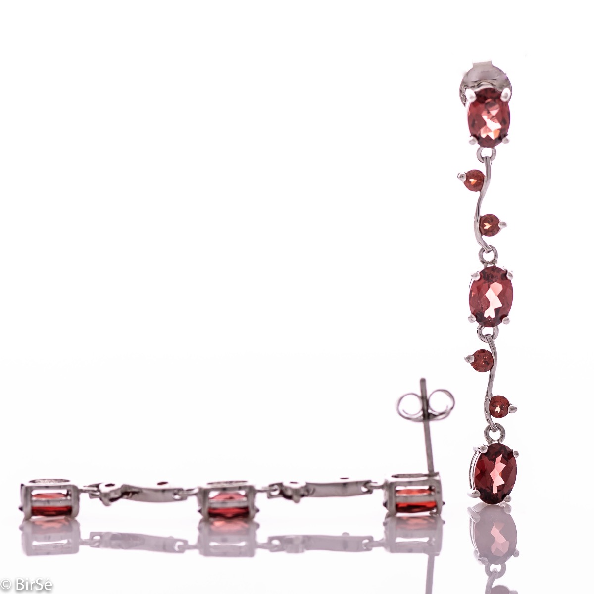 Extremely impressive dangling earrings with delicate workmanship combining numerous natural garnet stones with shiny rhodium silver.