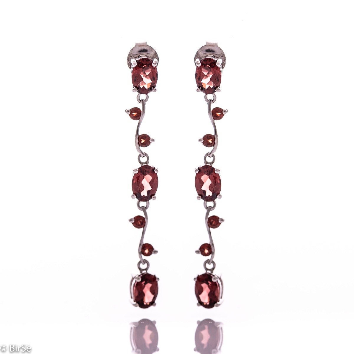 Extremely impressive dangling earrings with delicate workmanship combining numerous natural garnet stones with shiny rhodium silver.