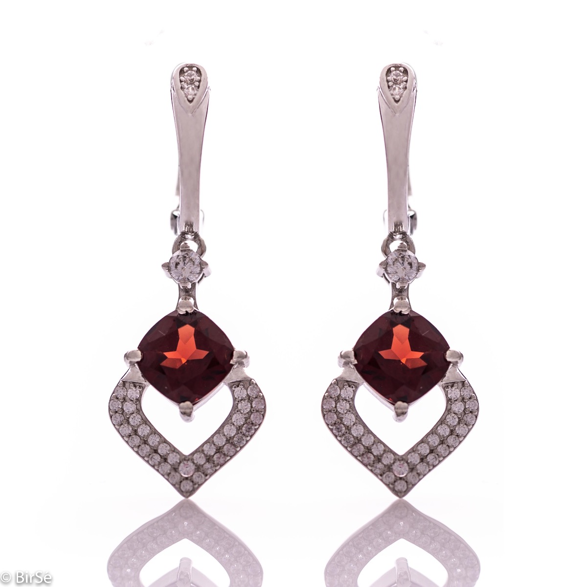 Dangling women's earrings with English clasp and exquisite craftsmanship combining delicate rhodium silver with radiant natural garnet and sparkling zircons. They can be combined with a ring and pendant of the same model.