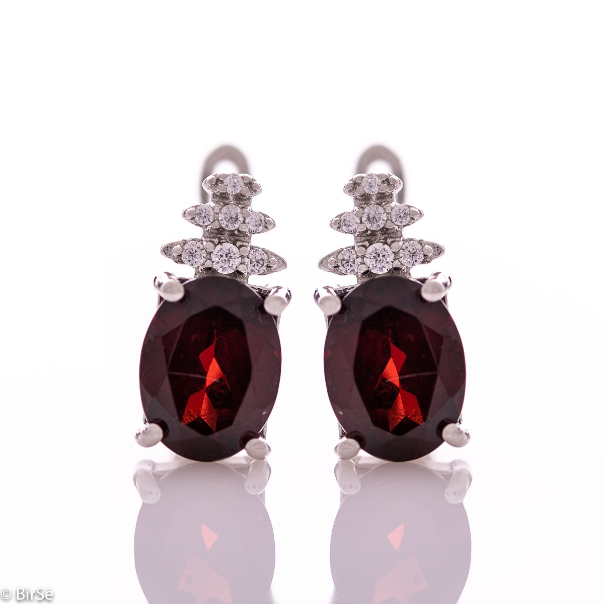 Elegant women's earrings with English clasp and delicate craftsmanship entirely of rhodium-plated silver, combined with radiant natural garnet and sparkling zircons. They can be combined with a ring and pendant of the same model.