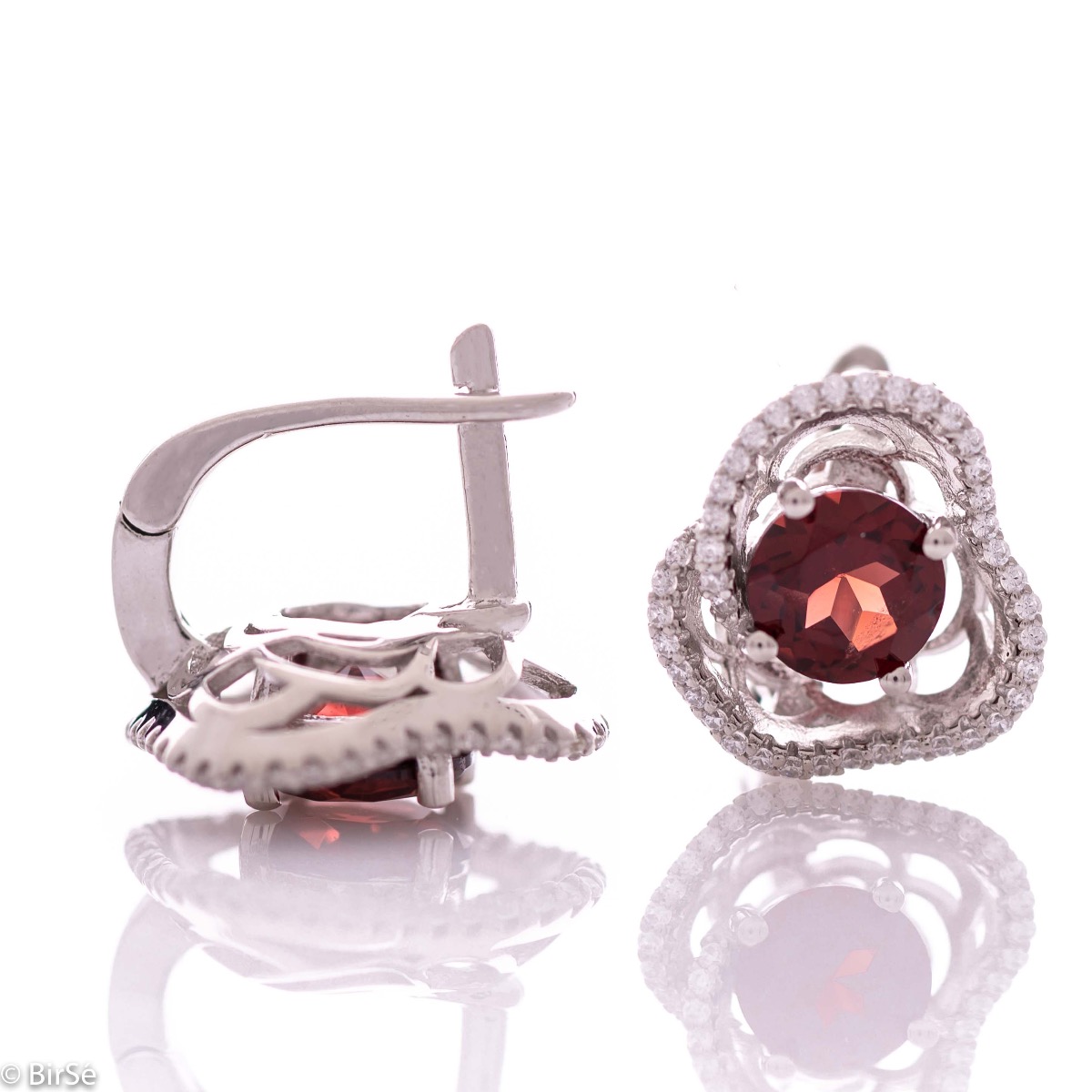 Elegant women's earrings with English fastening and exquisite workmanship entirely of rhodium-plated silver complemented by the glow of natural garnet and sparkling zircons. They can be combined with a ring and pendant of the same model.