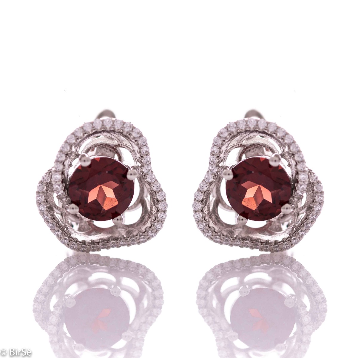 Elegant women's earrings with English fastening and exquisite workmanship entirely of rhodium-plated silver complemented by the glow of natural garnet and sparkling zircons. They can be combined with a ring and pendant of the same model.