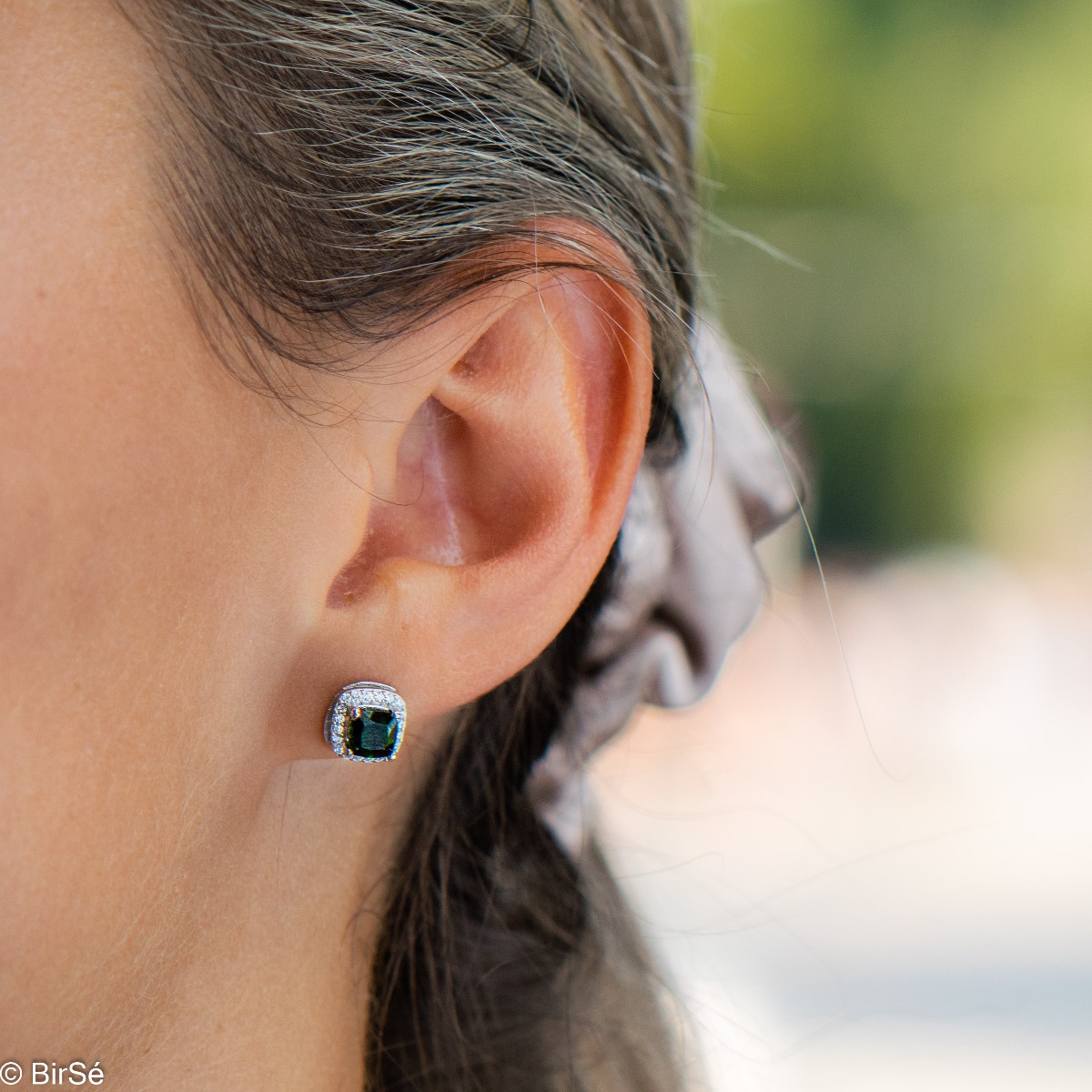 Finely crafted rhodium silver stud earrings with stunning natural chrome diopside in the center surrounded by sparkling cubic zirconias. Can be combined with a ring and pendant from the set.